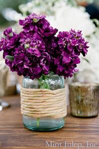 Radiant orchid barn wedding centerpiece